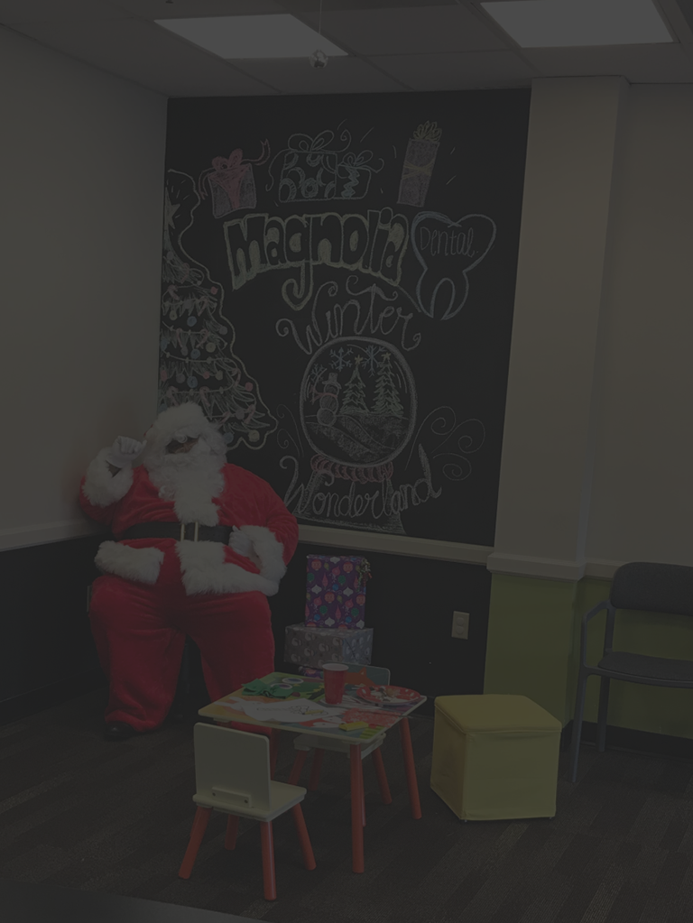 An image of a Santa Claus waiting to the patients to handover gifts