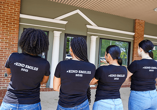four ladies with kind smiles shirt